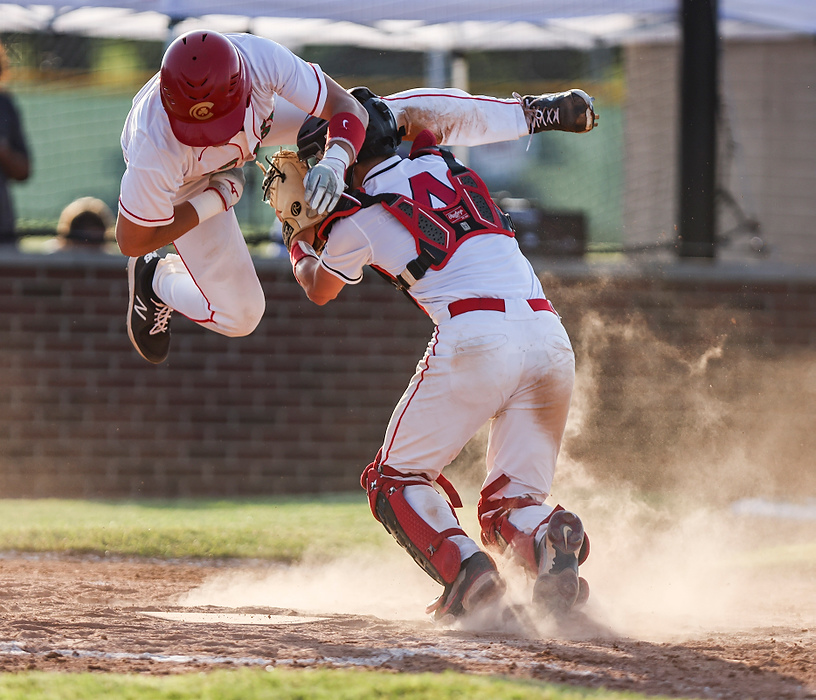 First place, Ron Kuntz Sports Photographer of the Year - Rebecca Benson / The BladeCentral Catholic’s Bishop Vargas (left) tries to jump over Oberlin Firelands’ catcher Corey Ransom at home plate during the Div II regional semifinal game at Carter Park in Bowling Green, on June 4, 2021. Central Catholic fell to Oberlin Firelands, 5-4. 