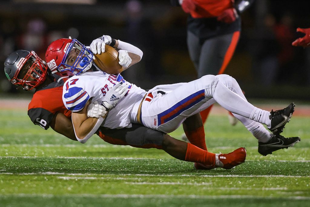 First place, Ron Kuntz Sports Photographer of the Year - Rebecca Benson / The BladeSt. Francis de Sales’ Trey Talboo is brought down by Central Catholic’s Dahveyon Greer during TRAC football game at Central Catholic High School in Toledo on October 22, 2021. 