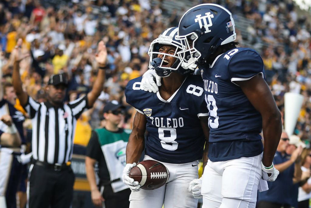 First place, Ron Kuntz Sports Photographer of the Year - Rebecca Benson / The BladeThe University of Toledo’s  Devin Maddox (left) celebrates his touchdown against Northern Illinois with Jerjuan Newton during a game in the Glass Bowl in Toledo on October 9, 2021. UT lost 22-20 to Northern Illinois. 