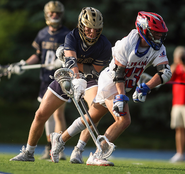 First place, Ron Kuntz Sports Photographer of the Year - Rebecca Benson / The BladeSt. John’s Jesuit’s Colton Bollenbacher (left) knocks St. Francis’ Grant Ansted’s stick out of his hands while moving the ball during the Division II regional semifinal lacrosse game at St. Francis de Sales High School in Toledo on May 24, 2021.