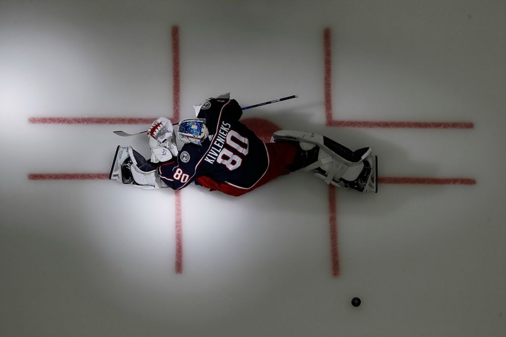 Second place, Ron Kuntz Sports Photographer of the Year - Adam Cairns / The Columbus DispatchColumbus Blue Jackets goaltender Elvis Merzlikins wears Matiss Kivlenieks jersey for warm-ups prior to the season opening NHL hockey game against the Arizona Coyotes at Nationwide Arena in Columbus on Oct. 14, 2021. 