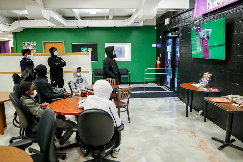 Second place, Ron Kuntz Sports Photographer of the Year - Adam Cairns / The Columbus DispatchWith weather being too cold to practice outside and an indoor soccer facility not yet being procured, members of the Hilltop Tigers hang out in the MyProjectUSA youth center watching soccer highlight videos from YouTube on the TV after school on Nov. 15.