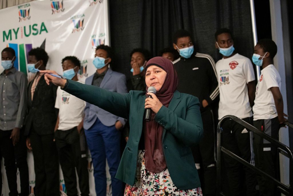 Second place, Ron Kuntz Sports Photographer of the Year - Adam Cairns / The Columbus DispatchWith Hilltop Tigers players lined up behind her, My Project USA founder and executive director Zerqa Abid makes a plea for donations to support youth programs like the Tigers during the My Project USA fall banquet on Nov. 7. My Project USA, which recently opened a youth center on Sullivant Avenue, provides Muslim social services and programming for kids in the Hilltop area.