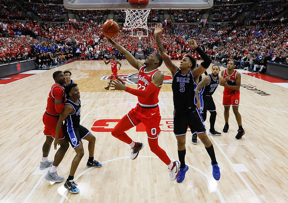 Second place, Ron Kuntz Sports Photographer of the Year - Adam Cairns / The Columbus DispatchOhio State Buckeyes guard Malachi Branham (22) shoots a layup around Duke Blue Devils forward Paolo Banchero (5) during the second half of the NCAA men's basketball game at Value City Arena in Columbus on Nov. 30, 2021. Ohio State won 71-66.