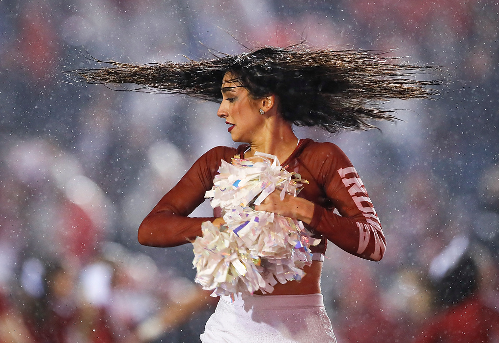 Second place, Ron Kuntz Sports Photographer of the Year - Adam Cairns / The Columbus DispatchA member of the Indiana Hoosiers Red Steppers dance team dances in the rain during the second quarter of the NCAA football game against the Ohio State Buckeyes at Memorial Stadium in Bloomington, Ind. on Oct. 23, 2021.