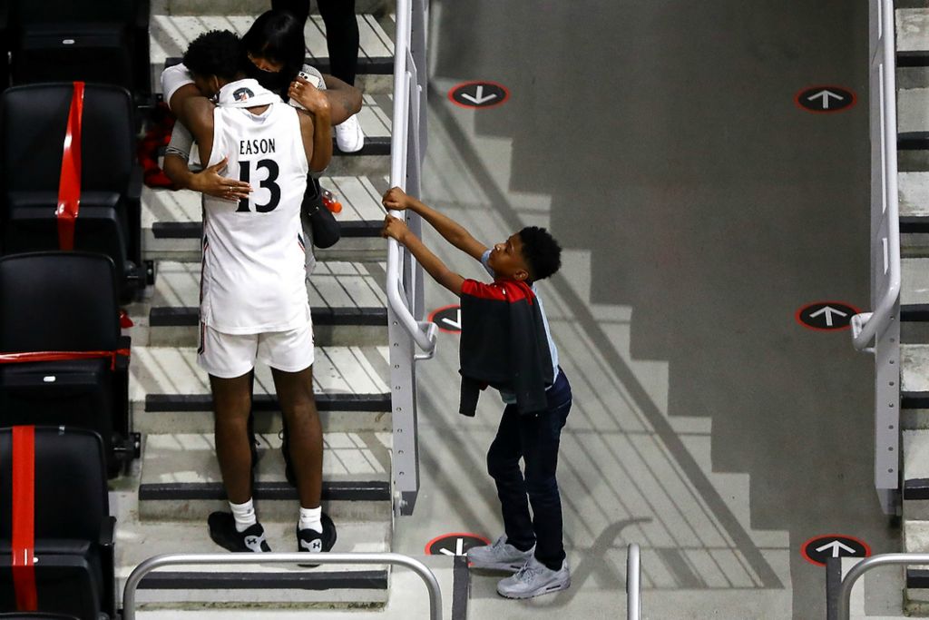 Third place, Ron Kuntz Sports Photographer of the Year - Kareem Elgazzar / The Cincinnati EnquirerCincinnati Bearcats forward Tari Eason (13) hugs his mother in the stands at the conclusion of a basketball game against the Tulane Green Wave on Feb. 26, 2021, at Fifth Third Arena in Cincinnati. The Cincinnati Bearcats won, 91-71. The game marked Eason’s last in a Bearcats uniform before entering the transfer portal.