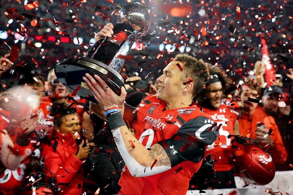 Third place, Ron Kuntz Sports Photographer of the Year - Kareem Elgazzar / The Cincinnati EnquirerCincinnati Bearcats quarterback Desmond Ridder (9) raises the trophy of the American Athletic Conference following the championship football game against the Houston Cougards on Dec. 4, 2021, at Nippert Stadium in Cincinnati. The Cincinnati Bearcats defeated the Houston Cougars, 35-20.