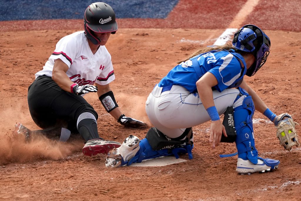 Third place, Ron Kuntz Sports Photographer of the Year - Kareem Elgazzar / The Cincinnati EnquirerTeam Canada infielder Jennifer Salling (7) scores a run in the fifth inning before Team Italy catcher Marta Gasparotto (19) can apply the tag during an opening-round game of the Tokyo 2020 Olympic Summer Games, July 26, 2021, at Yokohama Baseball Stadium in Yokohama, Japan.