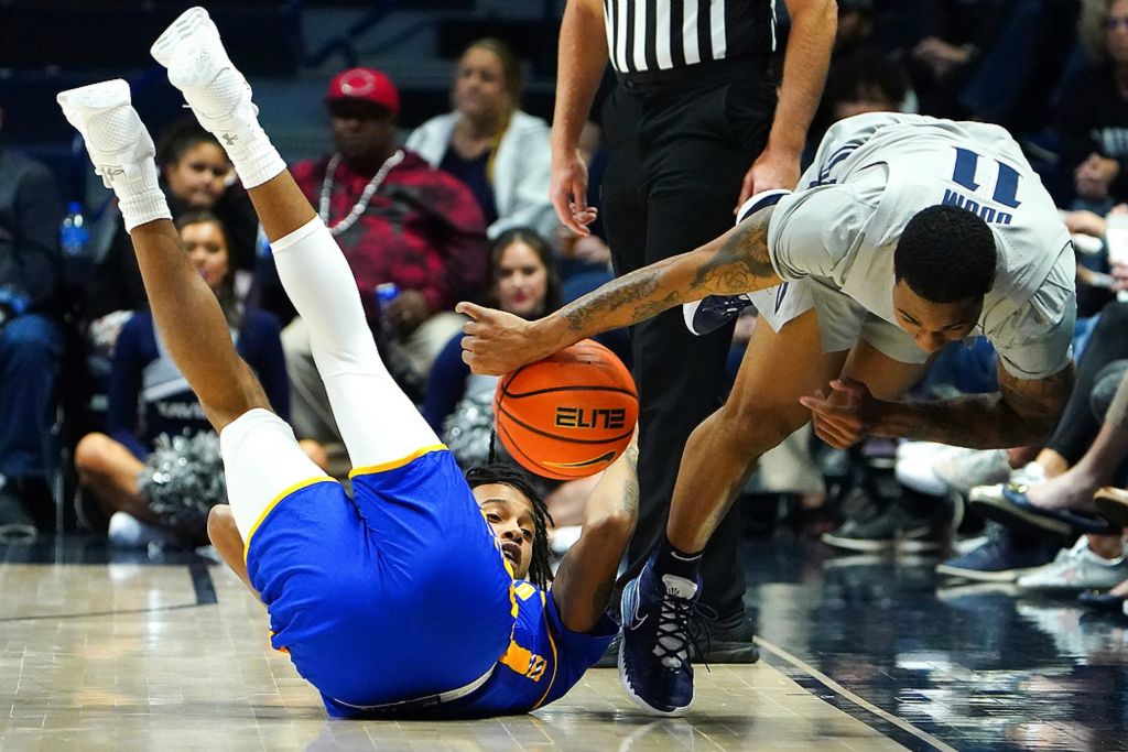 Third place, Ron Kuntz Sports Photographer of the Year - Kareem Elgazzar / The Cincinnati EnquirerMorehead State Eagles forward Jaylon Hall (left) and Xavier Musketeers guard Dwon Odom compete for a loose ball in the second half of a game, Dec. 15, 2021, at Cintas Center in Cincinnati. The Xavier Musketeers defaced the Morehead State Eagles, 86-63.