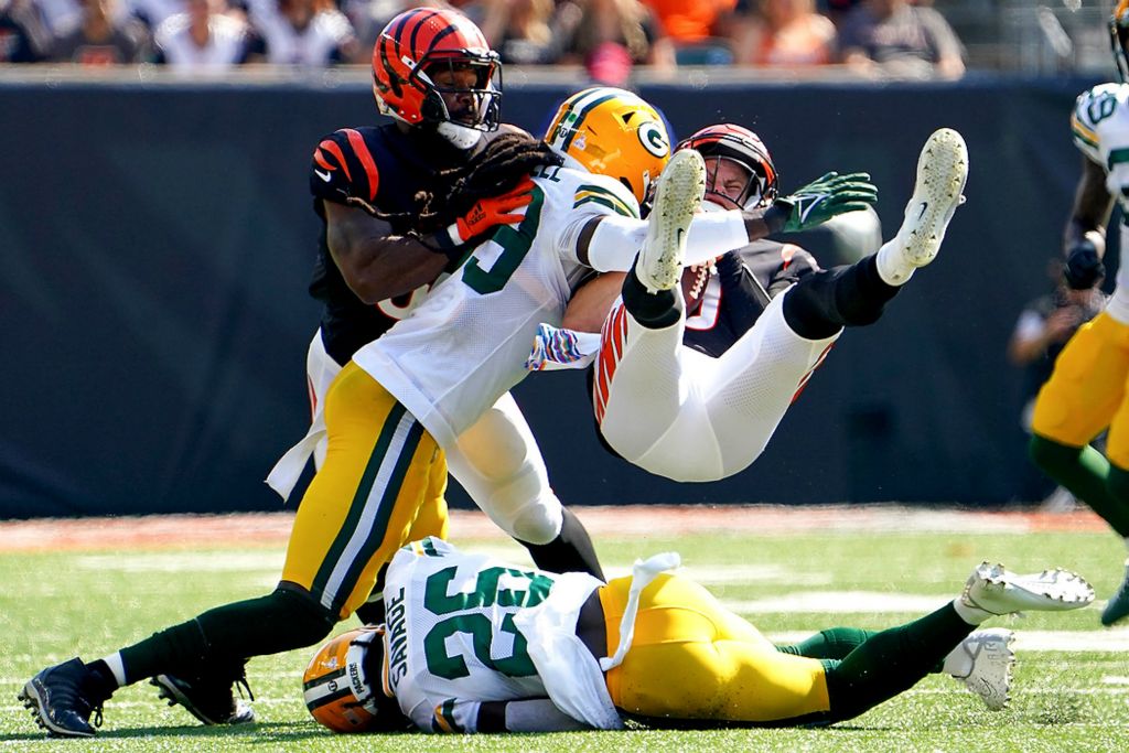 Third place, Ron Kuntz Sports Photographer of the Year - Kareem Elgazzar / The Cincinnati EnquirerCincinnati Bengals quarterback Joe Burrow (9) is up-ended by Green Bay Packers free safety Darnell Savage (26) in the second quarter of a game on Oct. 10, 2021, at Paul Brown Stadium in Cincinnati. 