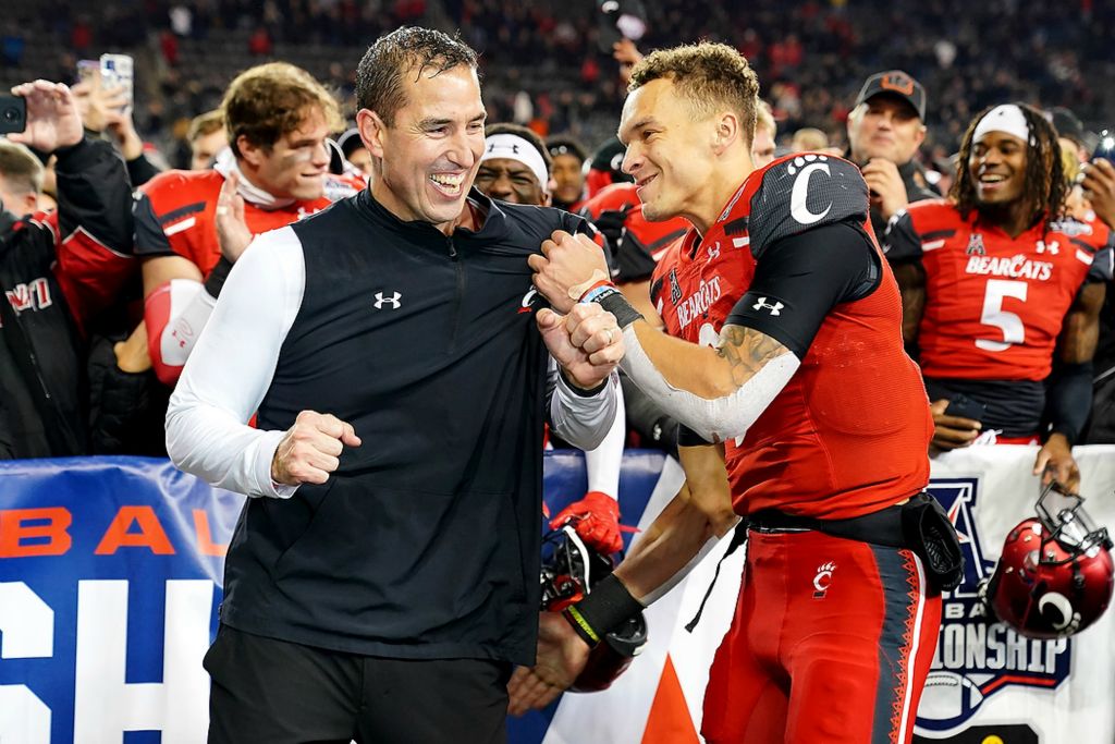 Third place, Ron Kuntz Sports Photographer of the Year - Kareem Elgazzar / The Cincinnati EnquirerCincinnati Bearcats head coach Luke Fickell (left)  and Cincinnati Bearcats quarterback Desmond Ridder (9) celebrate the victory in the American Athletic Conference championship football game on Dec. 4, 2021, at Nippert Stadium in Cincinnati. The Cincinnati Bearcats defeated the Houston Cougars, 35-20. 