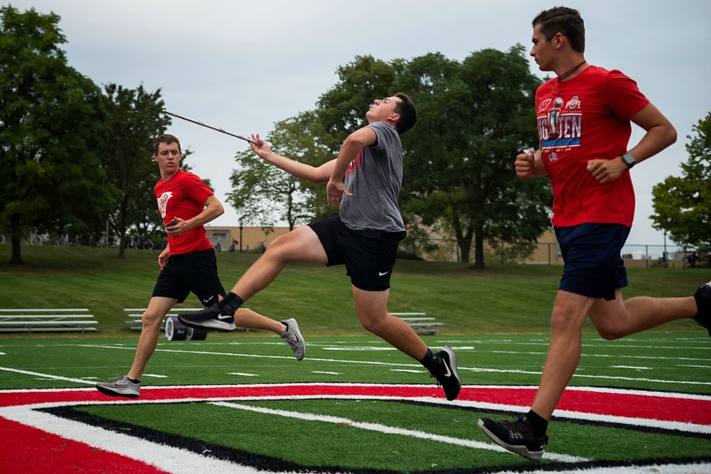 First place, Sports Picture Story - Joshua A. Bickel / The Columbus Dispatch, “Austin Bowman Leads the Way”Ohio State University Marching Band Drum Major Austin Bowman, left, and assistant drum major Dalton Cararo, right, run alongside Ethan Kelly, center, as they practice the drum major's entrance during rehearsal on Monday, Sept. 20, 2021 at Ohio State University in Columbus, Ohio. Aside from preparing and performing a different show each week, one of Austin’s responsibilities is helping teach the next generation of drum majors.