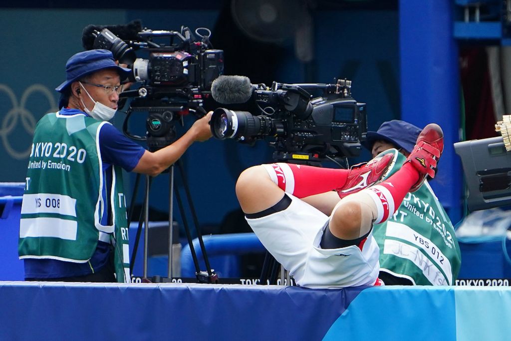 Second place, Sports Picture Story - Kareem Elgazzar / The Cincinnati Enquirer, “Olympic Softball”Team Japan infielder Yu Yamamoto (5) falls over the barricade to try to make a catch in the sixth inning against Team United States in the opening round softball match during the Tokyo 2020 Olympic Summer Games, July 26, 2021, at Yokohama Baseball Stadium. The Japan Olympics Committee elected not to build a softball-specific venue, opting to use an existing baseball stadium to stage the softball games ahead of the baseball competition. Athletes weren’t used to some of the nuances of the retrofitted field of play.