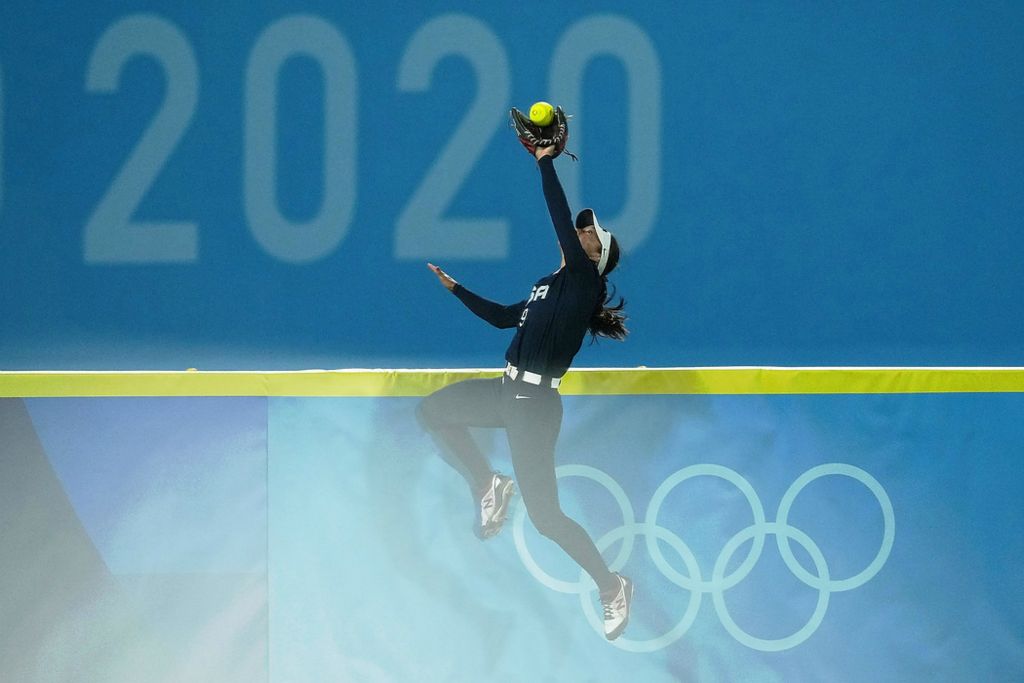 Second place, Sports Picture Story - Kareem Elgazzar / Kareem Elgazzar-USA TODAY Sports, “Olympic Softball”Team United States left fielder Janette Reed (9) makes a catch at the left-field wall, robbing a potential two-run home run against Japan during the seventh inning in the gold medal game of the Tokyo 2020 Olympic Summer Games, July 27, 2021, at Yokohama Baseball Stadium. Japan won 2-0. 