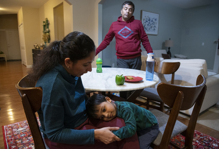 Student Photographer of the Year - First Place, Akash Pamarthy / Ohio UniversityRidhay Vemuri, 2, rests on his mother's lap at their dinner table in Novi, Michigan on Oct. 15. “He might adapt things from the American culture or other cultures and feel a little different compared to the other kids but should not receive it in a negative aspect but embrace his dual identity,” says Keerthi.  