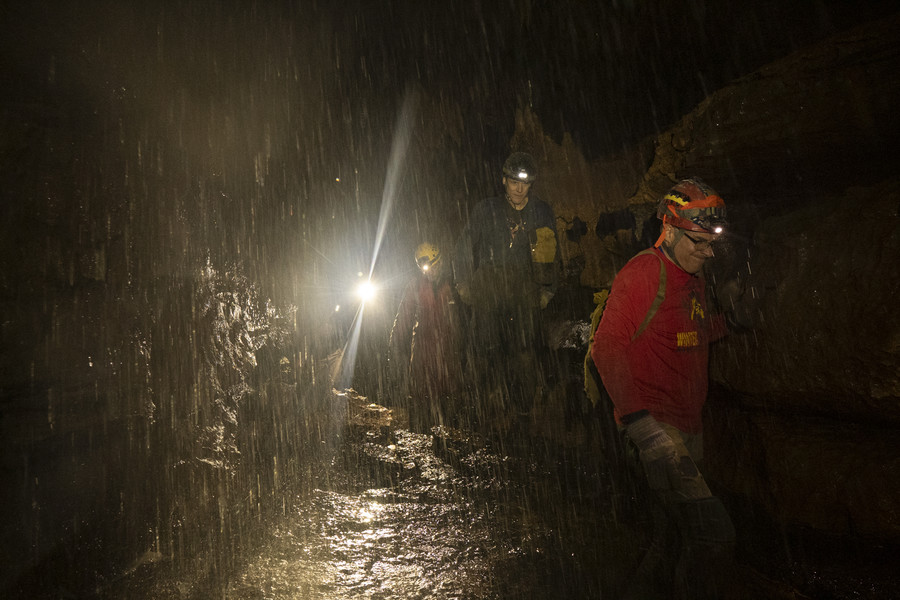Student Photographer of the Year - Second Place, Joe Timmerman / Ohio UniversityThe group of cavers walk past a waterfall in Roppel Cave while making their way out of the cave. 