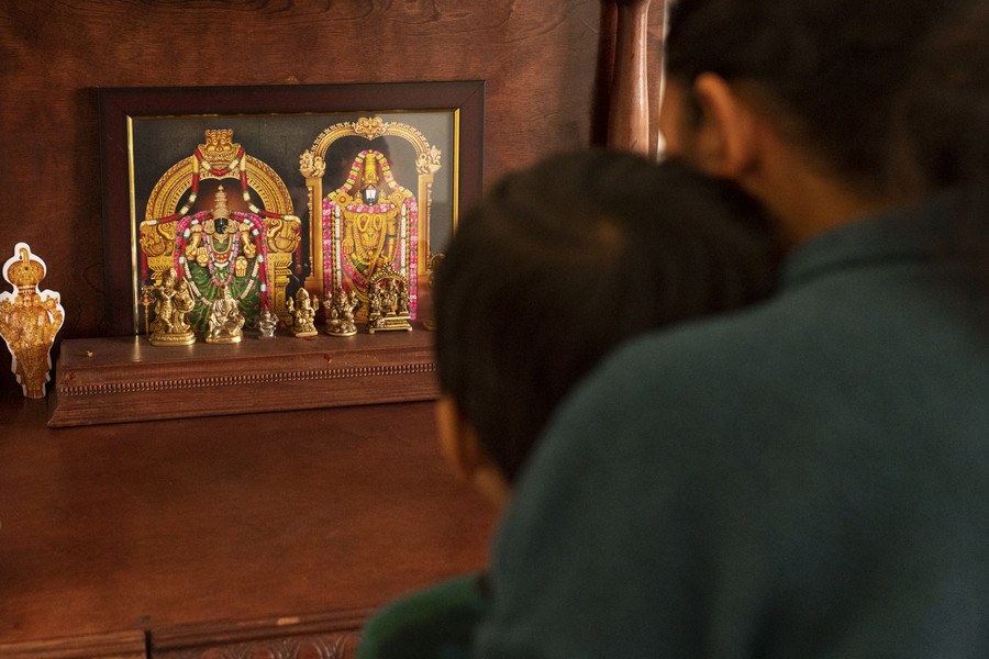 Feature Picture Story - First Place, “Telugu Americans”Ridhay Vemuri, 2, and his mother Keerthi Sanivarapu, 35, pray to the Indian deities in their prayer room at their residence in Novi, Michigan.   (Akash Pamarthy / Ohio University)