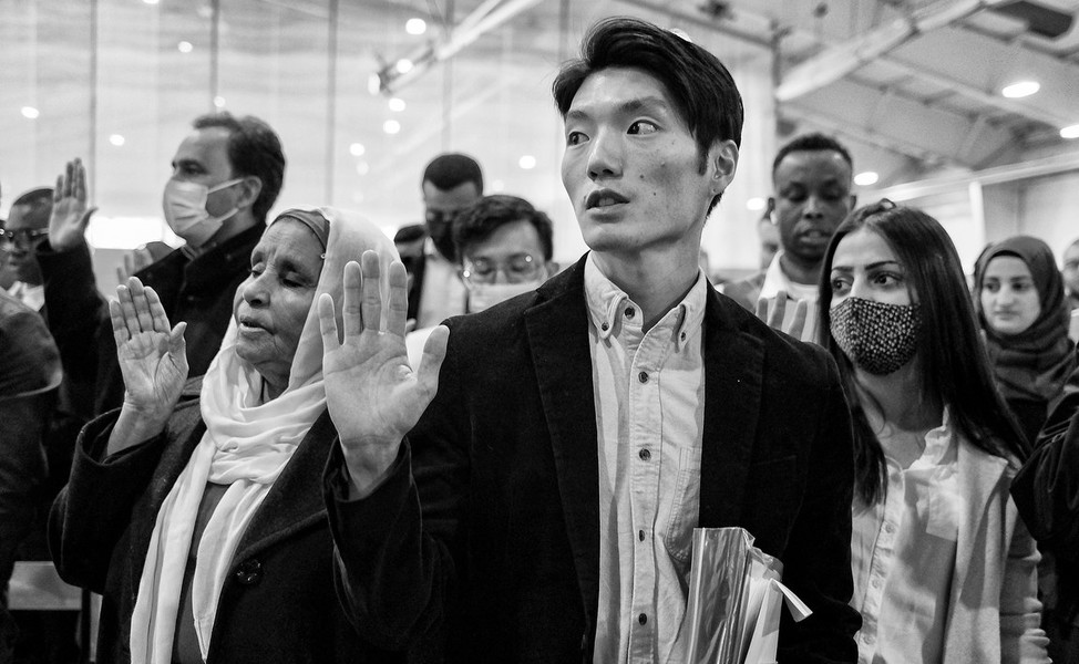 Feature Picture Story - Third Place, “Naturalization Ceremony”Kyoung Ha Jo, originally from South Korea, takes the oath of citizenship during a naturalization ceremony at the University of Findlay's Koehler Complex in Findlay.  (Jeremy Wadsworth / The Blade)