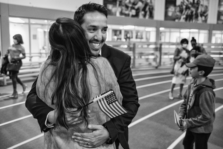 Feature Picture Story - Third Place, “Naturalization Ceremony”Alfredo Blank, originally from Mexico, hugs his wife Cinthya Blank after becoming a U.S. citizen during a naturalization ceremony at the University of  of Findlay's Koehler Complex in Findlay.  (Jeremy Wadsworth / The Blade)