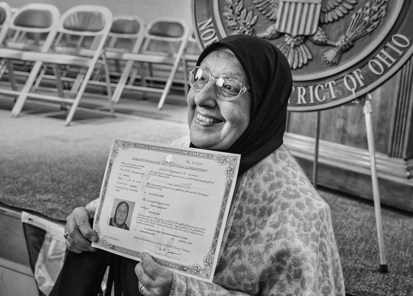 Feature Picture Story - Third Place, “Naturalization Ceremony”Eiman Zamalkani originally from Syria holds her certificate of citizenship proudly after a Naturalization Ceremony at St. Rose School in Perrysburg.    (Jeremy Wadsworth / The Blade)