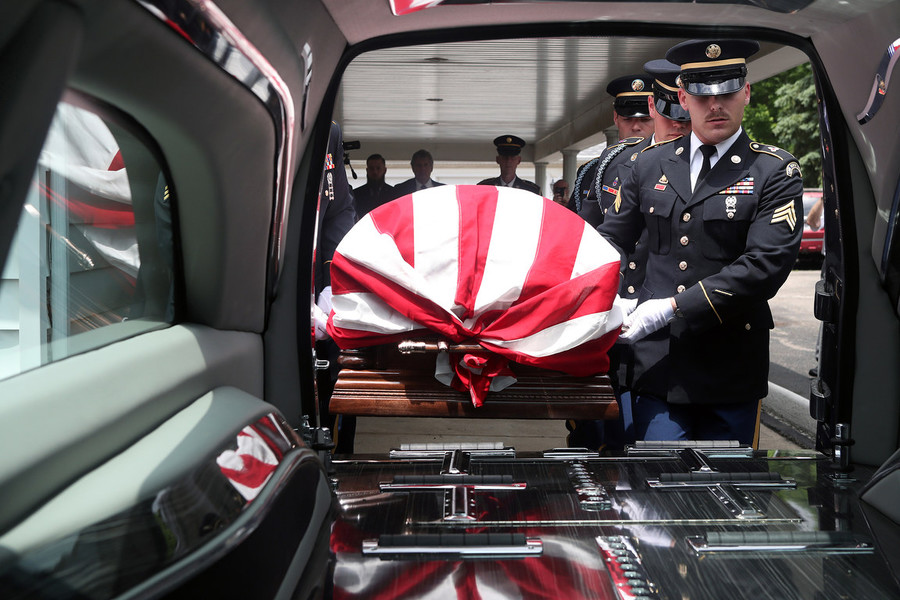 News Picture Story - Second Place, “Korean War Vet”Sgt. Brendan Tisher carries the remains of Korean War Army veteran private first class Jack E. Lilley with fellow Ohio Army National Guard Honor Guard Team members to a nearby hearse following a service held at Hill Funeral Home on June 14, 2022,  in Westerville.   (Shane Flanigan / ThisWeek Community News)