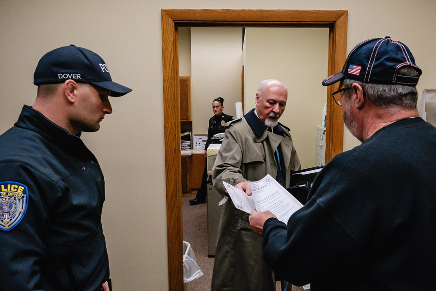 Ohio Understanding Award - First Place, “Mayor of Dover”Dover Mayor Richard Homrighausen hands paperwork to Safety Director Gerry Mroczkowski after firing him, the mayor's secretary, and the safety director, Dec 21 in Dover.  (Andrew Dolph / The Times Reporter)