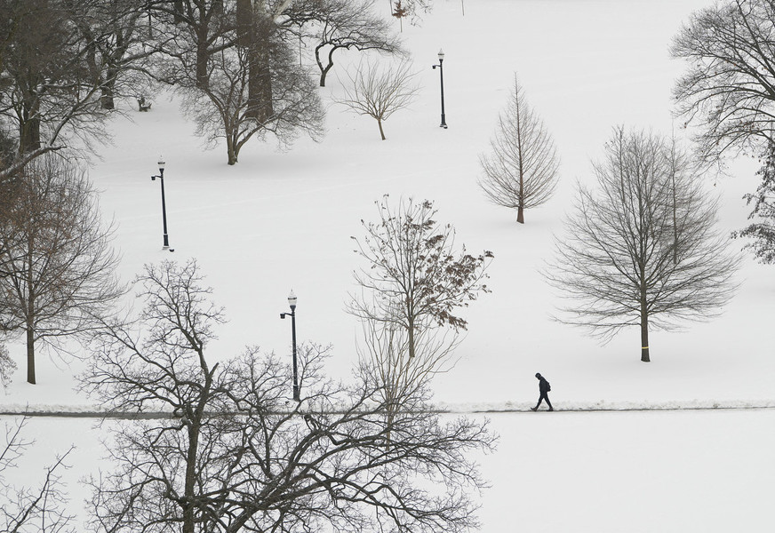 Photographer of the Year - Large Market - First Place, Adam Cairns / The Columbus DispatchA day after the campus was closed due to Winter Storm Landon, a student crosses the Oval as classes resume at Ohio State University. 