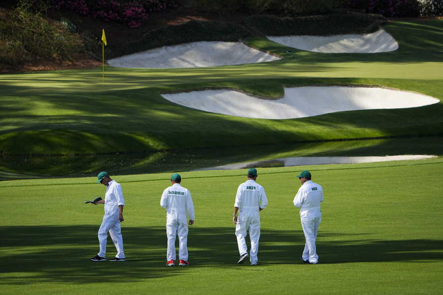 Photographer of the Year - Large Market - First Place, Adam Cairns / The Columbus DispatchCaddies check out approach positions on the 13th fairway during a practice round of The Masters golf tournament at Augusta National Golf Club.  
