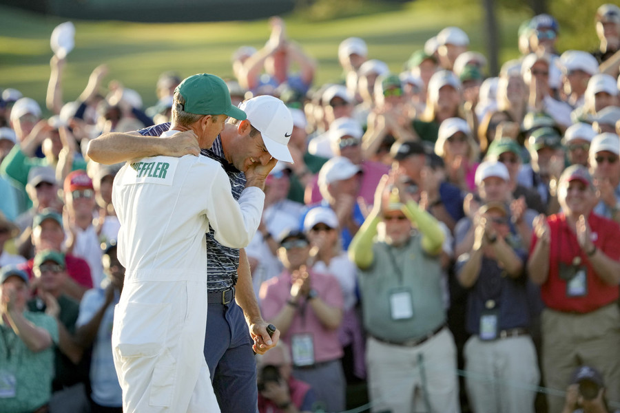 Photographer of the Year - Large Market - First Place, Adam Cairns / The Columbus DispatchScottie Scheffler celebrates with his caddie, Ted Scott, after finishing his round on the 18th hole during the final round of the Masters Tournament at Augusta National Golf Club. 