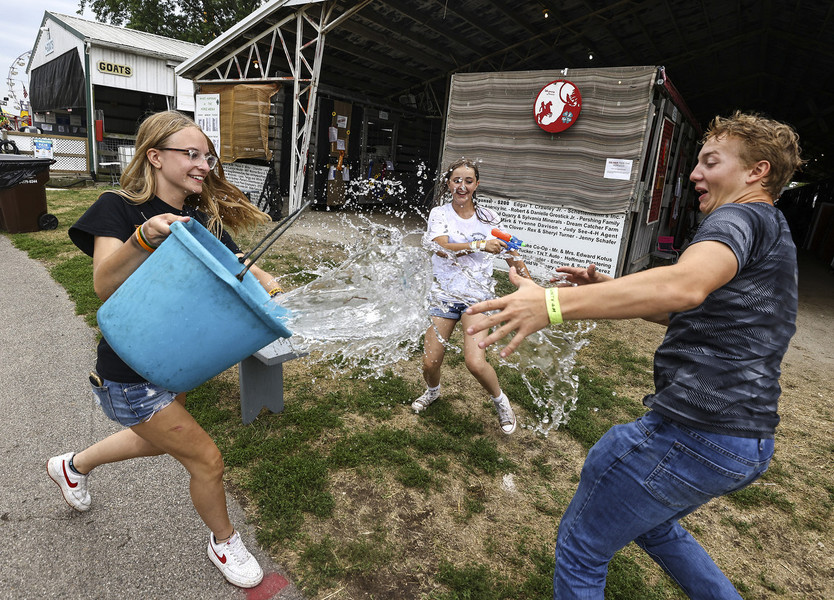 Photographer of the Year - Large Market - Second Place, Jeremy Wadsworth / The BladeFrom left Tatum Weakly, 16, of Monroe escalates a water gun fight with a bucket of water along with her friends Elizabeth Gomez, 15, of Huron and Ethan Layton, 16, of Dundee at the Monroe County Fair in Monroe, Michigan.   