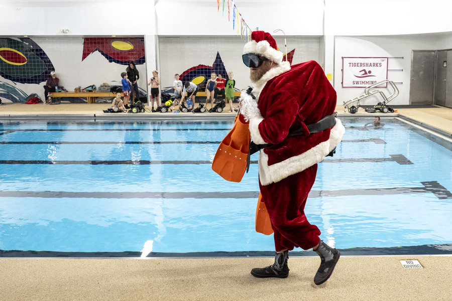 Photographer of the Year - Large Market - Award of Excellence, Joseph Scheller / Ohio UniversityScott Heidrich walks down the side of the pool wearing scuba diving gear underneath a Santa Claus outfit before making underwater pictures with children for an event hosted by Columbus Scuba at Oakstone Academy in Westerville2. “He just wants people to love scuba diving because he loves it so much,” said Anne Heidrich, his wife. 