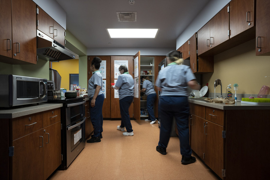 Photographer of the Year - Large Market - Award of Excellence, Joseph Scheller / Ohio UniversityInmates move about the kitchen inside of the Hope House at the Ohio Reformatory for Women in Marysville. Individuals in the ABCs program purchase their own food from a dispensary inside of the prison and take it back with them to the Hope House, where they live. 
