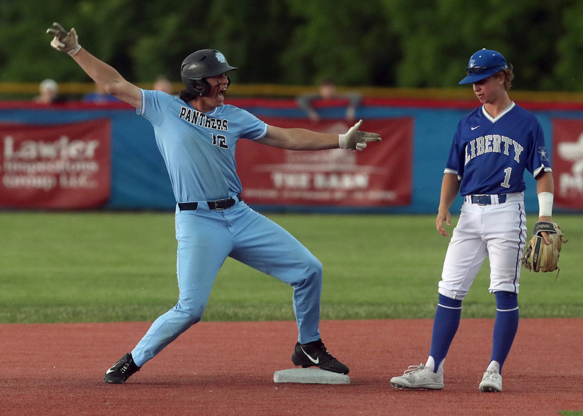 Photographer of the Year - Small Market - First Place, Shane Flanigan / ThisWeek Community NewsHilliard Darby's Casey Maruniak celebrates a two-run double in front of Olentangy Liberty's Josh Stickel during a Division I district final game at Grove City High School. The game was postponed due to inclement weather with Darby leading Liberty, 4-0, in the second inning. 