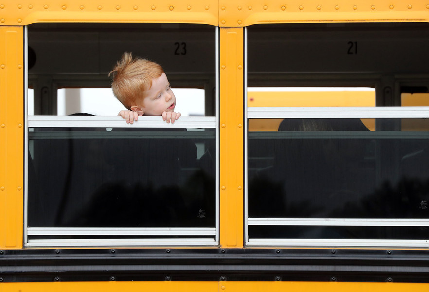 Photographer of the Year - Small Market - First Place, Shane Flanigan / ThisWeek Community NewsRyan McCann, 3, of Grove City, peers out a bus window during the South-Western City Schools' First-Time Bus Rider program at Central Crossing High School in Grove City. 