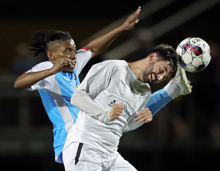 Sports Feature - Third Place, “Header”Akron FC’s Chewe Mukuka (left) and Pittsburgh’s Owain Hawkins both make a play for the ball during the second half of the Akron’s first soccer game at STVM’s John Cistone Field. (Jeff Lange / Akron Beacon Journal)