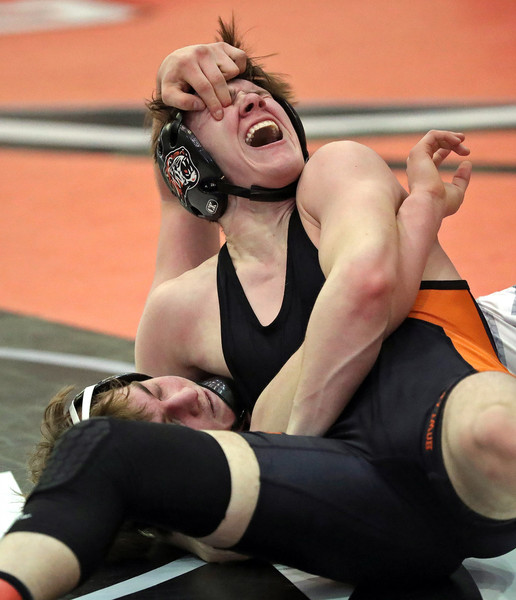 Sports Feature - Second Place, “Eye Gouge”Aurora’s Bo DiJulius (bottom) gouges the eye of Howland’s Carter Mock to be disqualified from the Division II district tournament during their 144 pound quarterfinal match at Perry High Schooll. (Jeff Lange / Akron Beacon Journal)