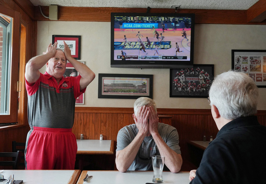 Sports Feature - Third Place, “Stress”From left: Moe Modecki of Columbus, Keith Olszewski of Dublin, and Tim Picciano of Dublin, react after Ohio State missed a shot during  the tense last minutes in their first round men's basketball game against Loyola Chicago at the Varsity Club. Their team, Ohio State, won, but the final minutes gave them a great deal of stress. (Fred Squillante / The Columbus Dispatch)
