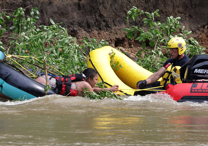 Spot News - Third Place, “River Rescue”Firefighters from the German Township Fire Department rescue one of four people who were trapped in the middle of the Mad River. The people were tubing on the swollen river when they got stuck on a tree that had fallen in the river. All four people were rescued safely.  (Bill Lackey / Springfield News-Sun)