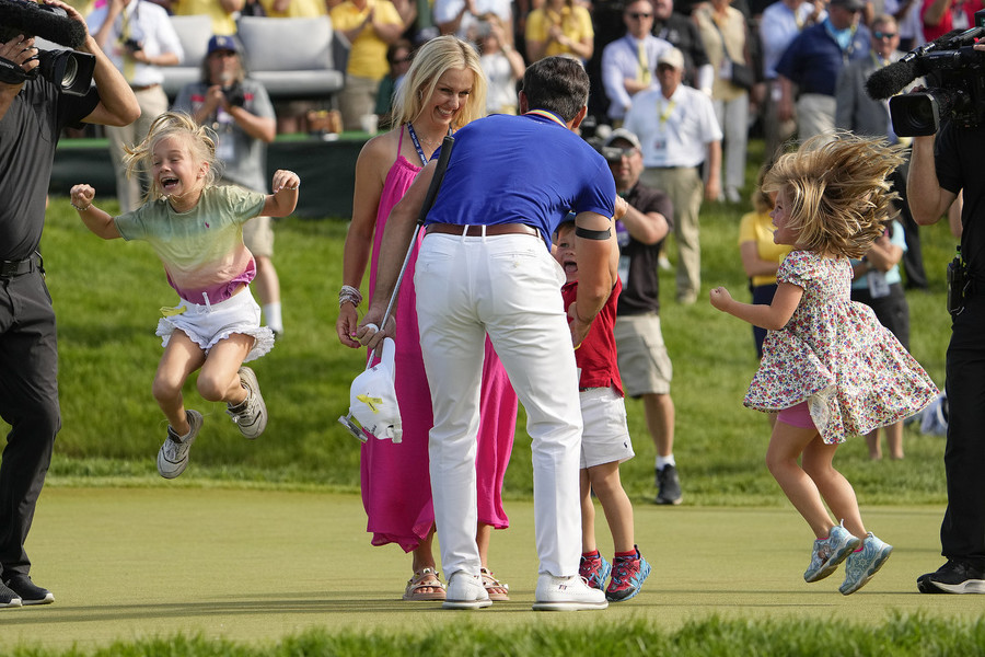 Ron Kuntz Sports Photographer of the Year - First Place Billy Horschel's family rushes out onto the 18th green to greet him after he wins the Memorial Tournament at Muirfield Village Golf Club.   (Adam Cairns / The Columbus Dispatch)