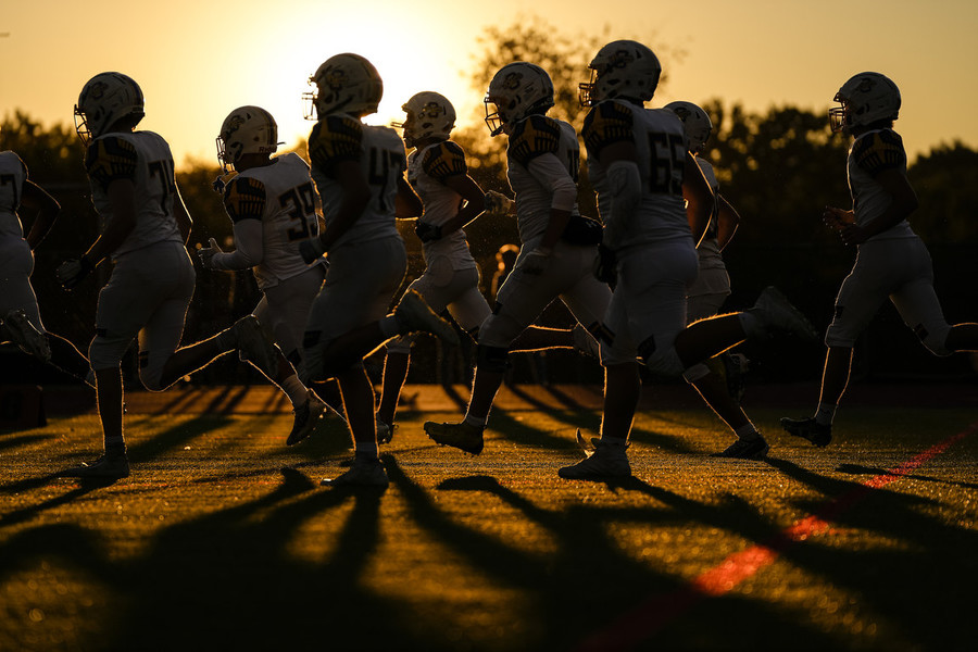 Ron Kuntz Sports Photographer of the Year - First Place The Olentangy Braves take the field prior to the high school football game against the Thomas Worthington Cardinals at Thomas Worthington High School.  (Adam Cairns / The Columbus Dispatch)