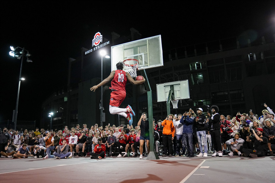 Ron Kuntz Sports Photographer of the Year - First Place Ohio State forward Brice Sensabaugh (10) competes in a slam dunk contest during the “Buckeyes on the Blacktop” event on the rec basketball courts behind Ohio Stadium.   (Adam Cairns / The Columbus Dispatch)