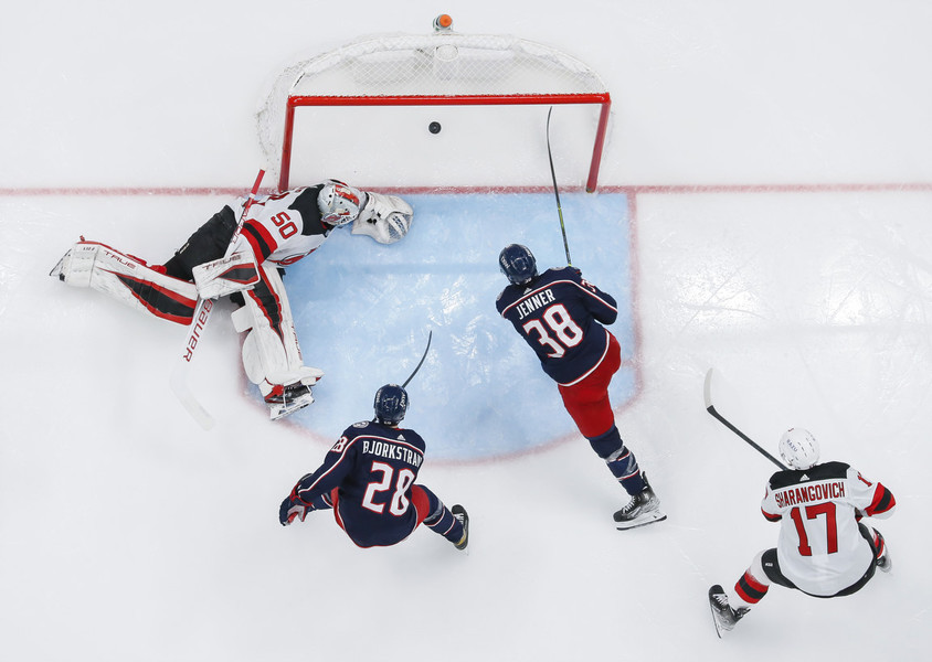 Ron Kuntz Sports Photographer of the Year - First Place Columbus Blue Jackets center Boone Jenner (38) scores a goal past New Jersey Devils goaltender Nico Daws (50) during the second period of the NHL hockey game at Nationwide Arena in Columbus.   (Adam Cairns / The Columbus Dispatch)