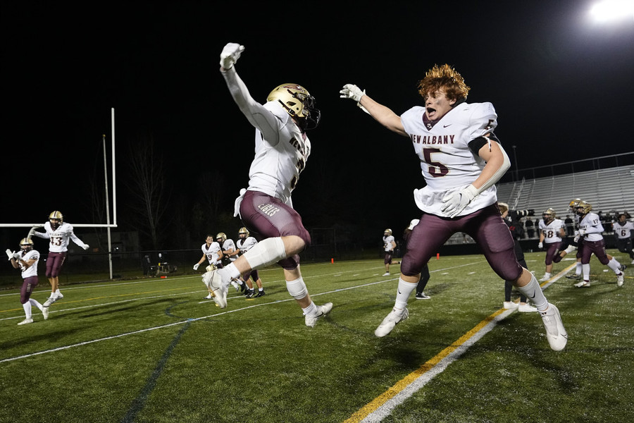 Ron Kuntz Sports Photographer of the Year - First Place New Albany's Dillon Schaub (3) and Roman Orsinelli (5) celebrate following their 20-7 win over the Upper Arlington Golden Bears in the Div. I regional semifinal high school football playoff game at Westerville Central.   (Adam Cairns / The Columbus Dispatch)