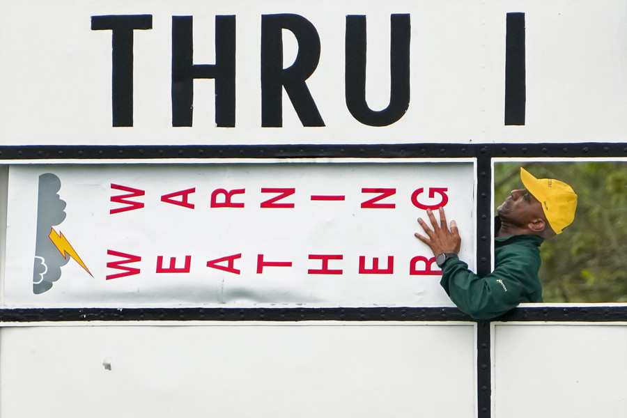 Ron Kuntz Sports Photographer of the Year - First Place With rain and lightning in the area, course workers put out a weather warning sign on a through board during a practice round of The Masters golf tournament at Augusta National Golf Club.   (Adam Cairns / The Columbus Dispatch)