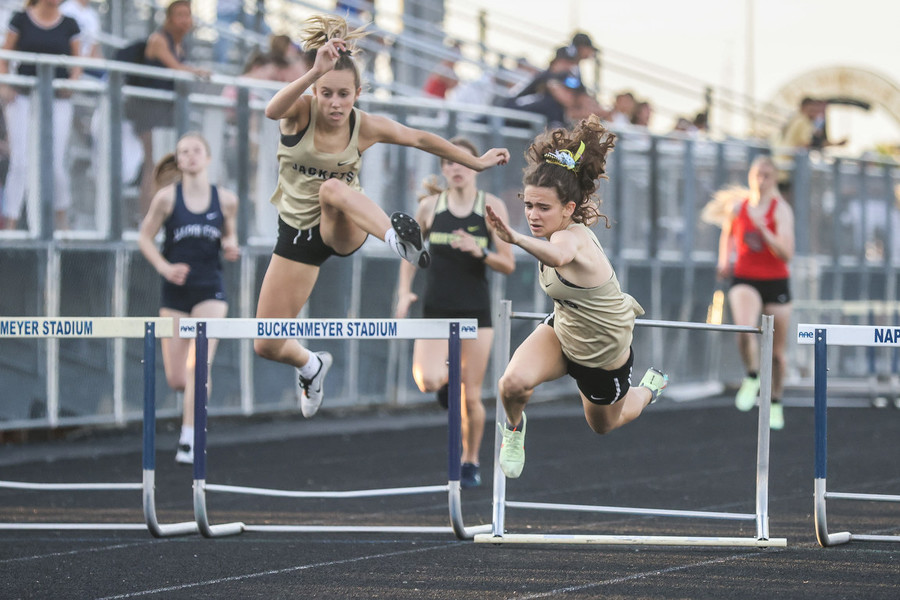 Ron Kuntz Sports Photographer of the Year - Second Place Perrysburg Yellow Jackets hurdler Laura Valette (right) loses her position in first place after falling over the last hurdle while competing in the 300 meter hurdles during the Northern Lakes League track and field championships at Napoleon High School in Napoleon.  (Isaac Ritchey / The Blade)