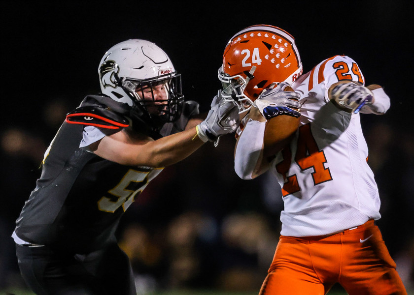 Ron Kuntz Sports Photographer of the Year - Second Place Northview Wildcats defensive lineman Dom Row (left) grabs onto the face mask of Southview Cougars running back Isaac Sexton during a Northern Lakes League Conference football game at Northview High School.   (Isaac Ritchey / The Blade)