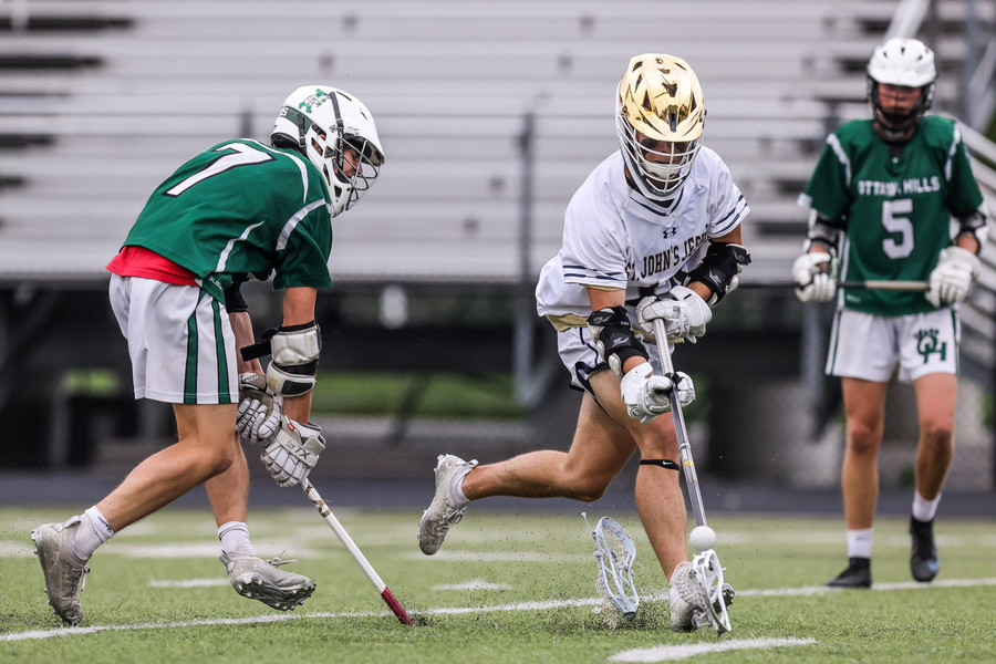 Ron Kuntz Sports Photographer of the Year - Second Place Ottawa Hills Green Bears midfielder Nat Jun (left) loses the head of his stick while battling for a loose ball with St. John’s Jesuit Titans attacker Cooper Hoyt in the OHSAA Division II  lacrosse regional final at St. John's Jesuit High School in Toledo.  (Isaac Ritchey / The Blade)
