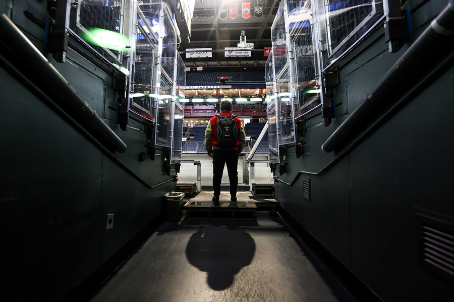 Ron Kuntz Sports Photographer of the Year - Second Place St. Francis De Sales’s Braden Caster looks out at an empty arena before the OHSAA state hockey championship game against Gates Mills Gilmour at Nationwide Arena in Columbus.  (Isaac Ritchey / The Blade)