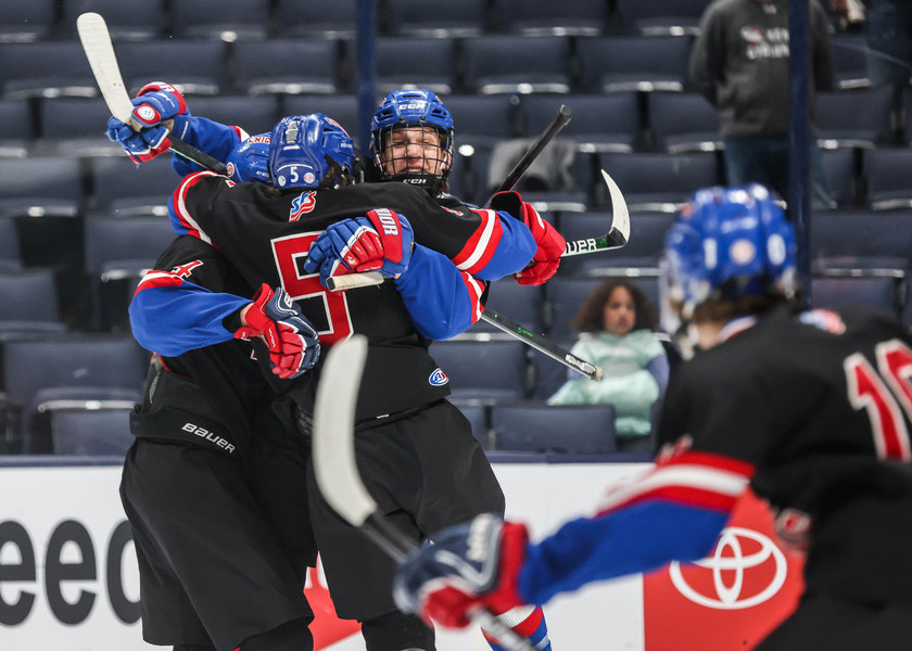 Ron Kuntz Sports Photographer of the Year - Second Place St. Francis De Sales’s Gordy Hunt is met with hugs from teammates after scoring a goal in the OHSAA state hockey championship game against Gates Mills Gilmour at Nationwide Arena in Columbus.  (Isaac Ritchey / The Blade)