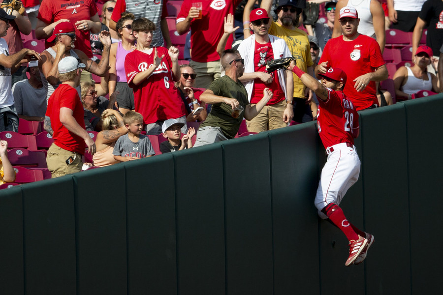 Ron Kuntz Sports Photographer of the Year - Third Place Cincinnati Reds left fielder Tommy Pham (28) catches a ball at the wall in the fifth inning of a game against the Atlanta Braves at Great American Ball Park in Cincinnati.  (Albert Cesare / The Cincinnati Enquirer)